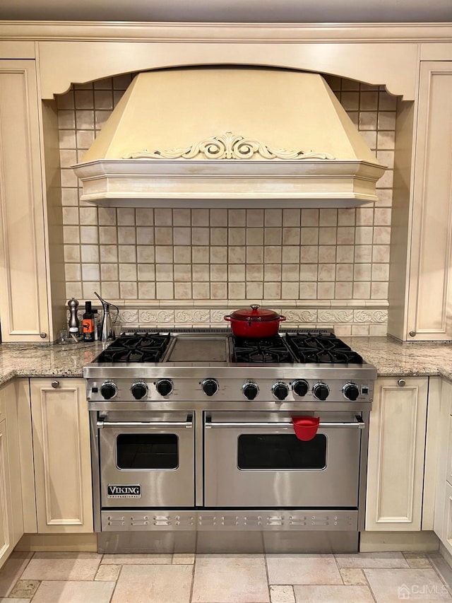 2 Gloucester Ct, East Brunswick, NJ 08816 - kitchen with range with two ovens, backsplash, light stone countertops, and premium range hood