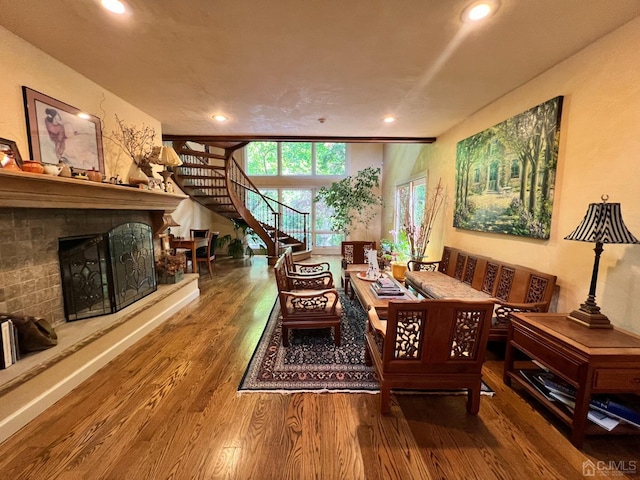 2 Gloucester Ct, East Brunswick, NJ 08816 - sitting room with stairway, recessed lighting, a fireplace with raised hearth, and wood finished floors