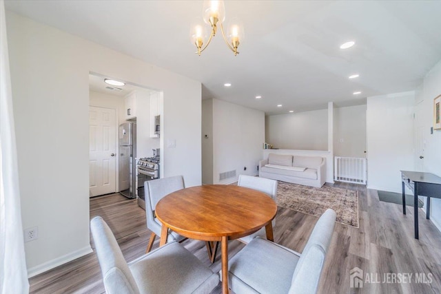 111 Beverly Hill Ter Unit A, Woodbridge Proper, NJ 07095 - dining space featuring light wood-type flooring, a chandelier, baseboards, and recessed lighting