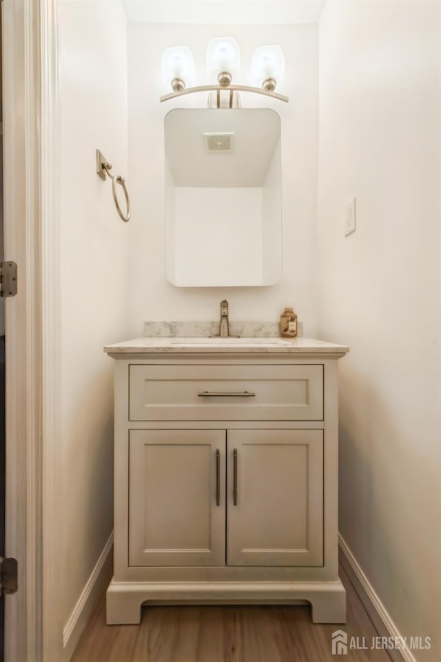 1 Webster Rd, Franklin, NJ 08873 - bathroom with baseboards, vanity, and wood finished floors