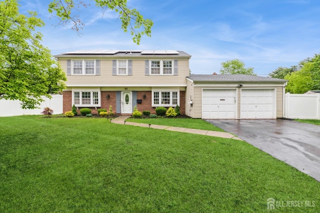 1 Webster Rd, Franklin, NJ 08873 - colonial inspired home with an attached garage, roof mounted solar panels, asphalt driveway, and brick siding