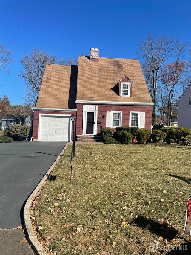 new england style home with a garage and a front lawn