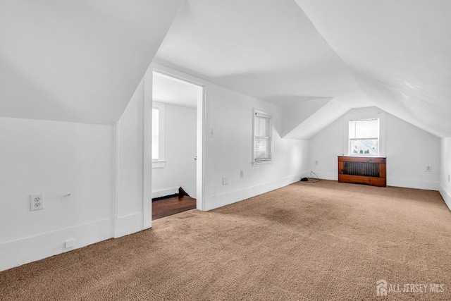 bonus room with carpet flooring, lofted ceiling, and baseboards
