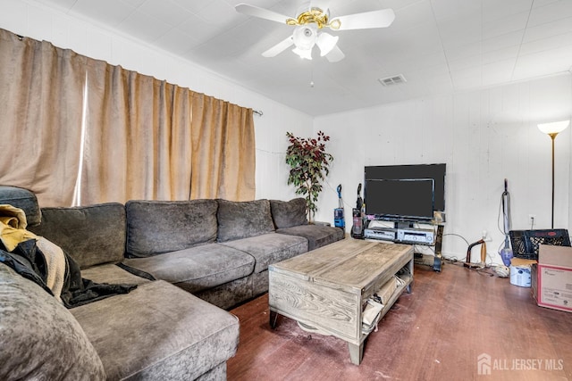 living area with a ceiling fan and wood finished floors