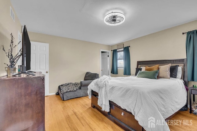 bedroom with visible vents and light wood finished floors