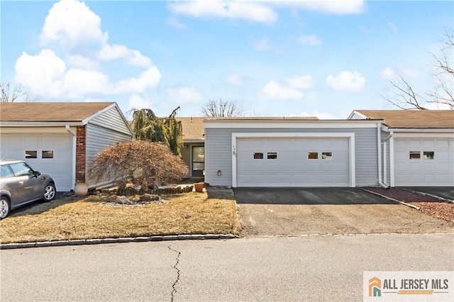 single story home with brick siding and a garage