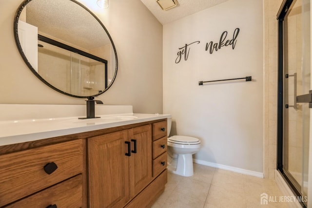 full bath featuring vanity, tile patterned flooring, toilet, a textured ceiling, and a shower stall