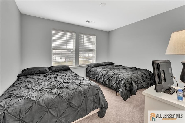 bedroom featuring carpet flooring and visible vents