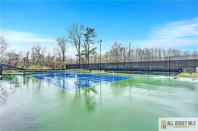 view of sport court with fence