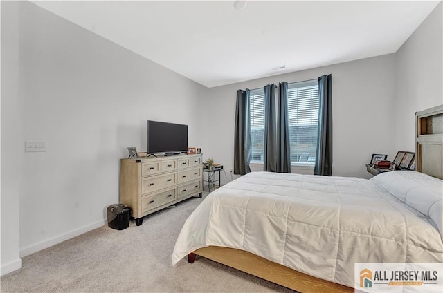 carpeted bedroom featuring baseboards