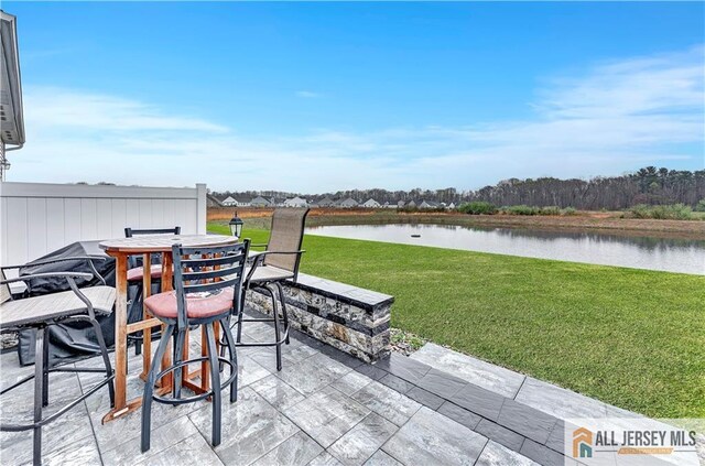 view of patio / terrace featuring outdoor dining area and a water view
