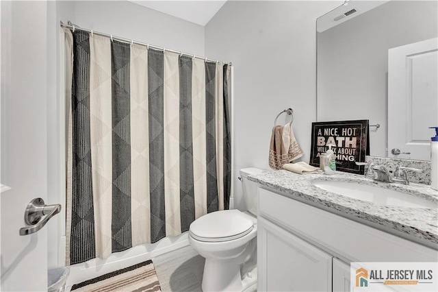 bathroom with vanity, shower / tub combo, toilet, and visible vents