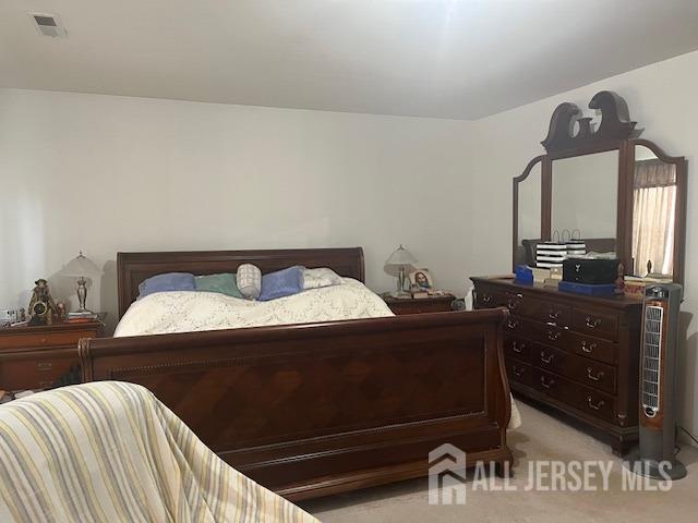 bedroom with light colored carpet