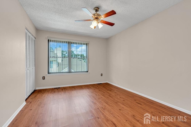 47 Covington Ct, East Brunswick, NJ 08816 - spare room with light wood-style floors, ceiling fan, and a textured ceiling