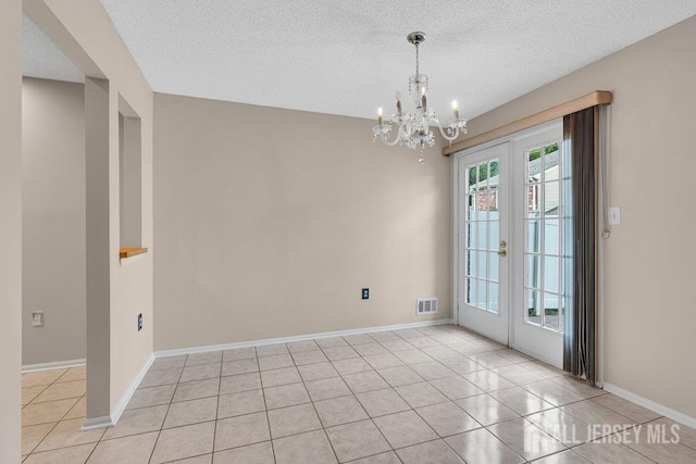 47 Covington Ct, East Brunswick, NJ 08816 - unfurnished room with french doors, a chandelier, light tile patterned floors, and a textured ceiling