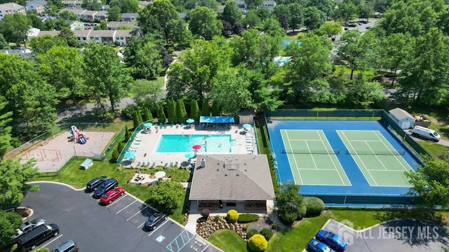 47 Covington Ct, East Brunswick, NJ 08816 - aerial view of a pool area and a tree filled landscape