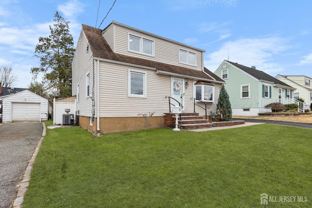 view of front facade with central air condition unit, an outbuilding, aphalt driveway, a detached garage, and a front yard