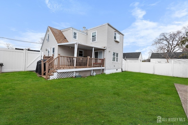 rear view of house featuring crawl space, a yard, a deck, and a fenced backyard