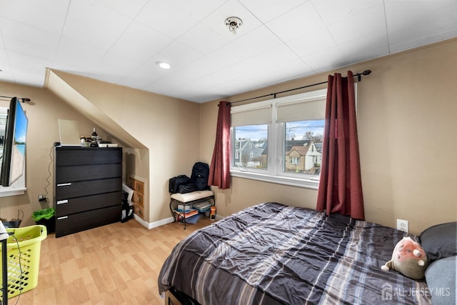 bedroom with baseboards and wood finished floors