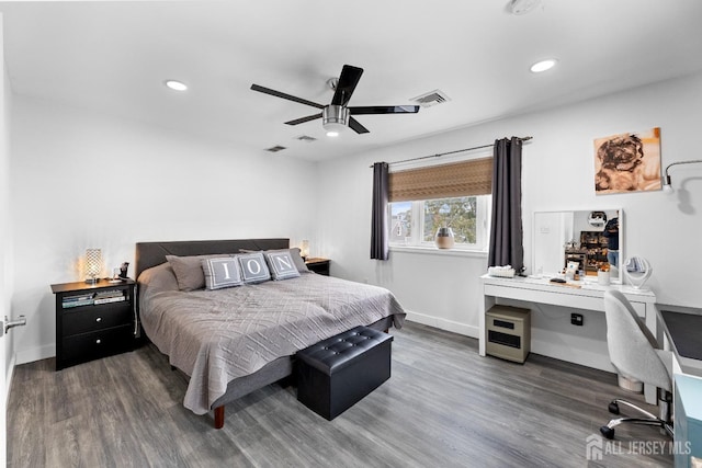 bedroom featuring baseboards, wood finished floors, and recessed lighting