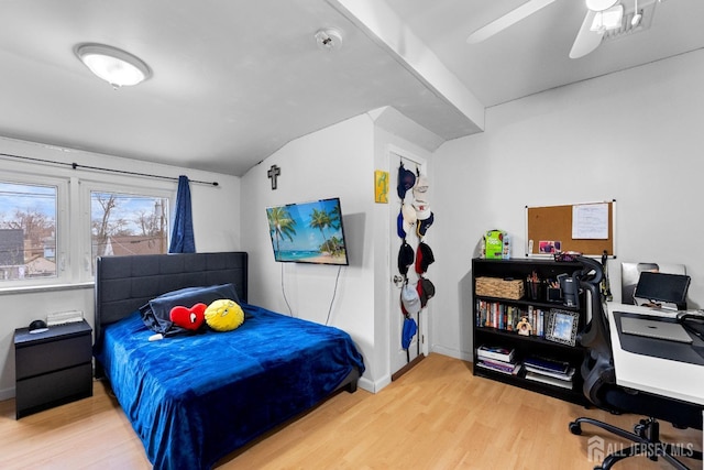 bedroom featuring vaulted ceiling, wood finished floors, baseboards, and ceiling fan