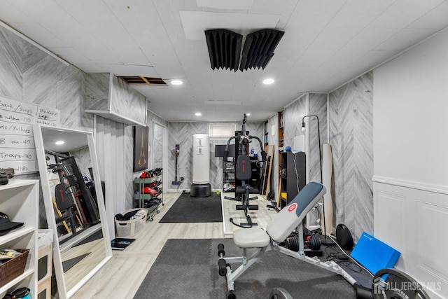 workout room with recessed lighting and wood finished floors