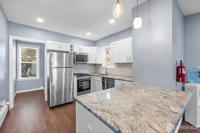 41 Guilden St, New Brunswick, NJ 08901 - kitchen with stainless steel appliances, light stone counters, white cabinets, decorative backsplash, and healthy amount of natural light