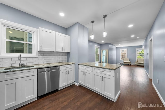 41 Guilden St, New Brunswick, NJ 08901 - kitchen featuring dishwasher, a peninsula, open floor plan, white cabinets, and backsplash