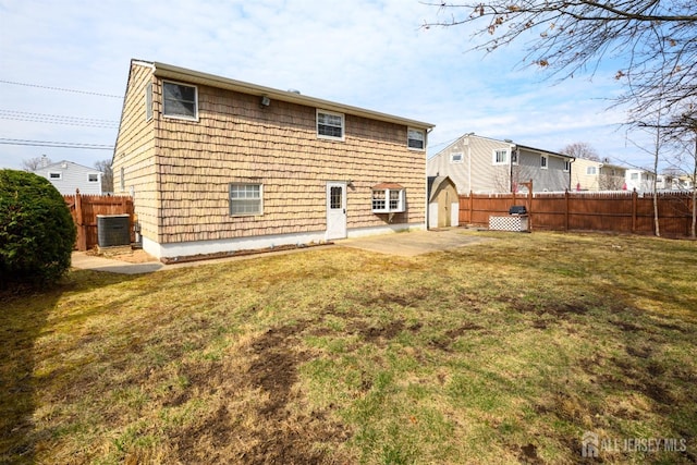 back of property featuring a yard, a patio area, central AC unit, and fence