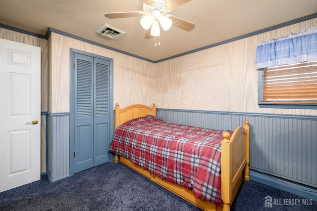 bedroom featuring visible vents, wainscoting, wallpapered walls, and carpet floors