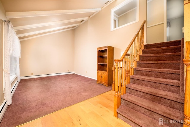 stairs with a baseboard radiator, carpet floors, and wood finished floors