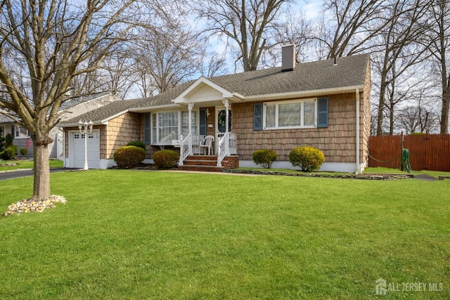 ranch-style home featuring fence, aphalt driveway, a front yard, a chimney, and a garage