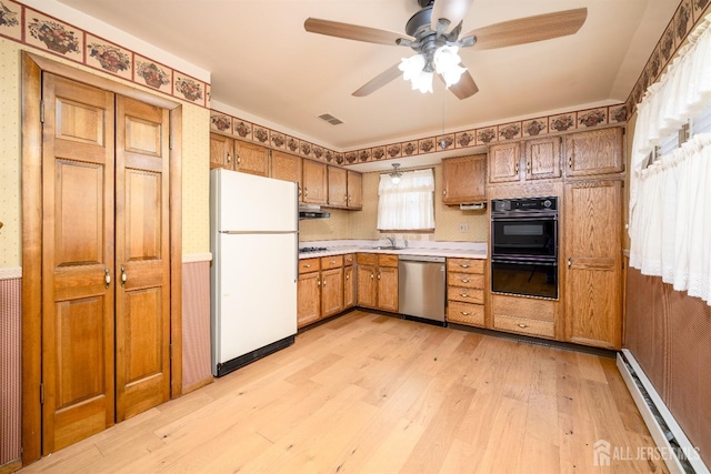 kitchen with visible vents, a baseboard heating unit, freestanding refrigerator, light countertops, and dishwasher