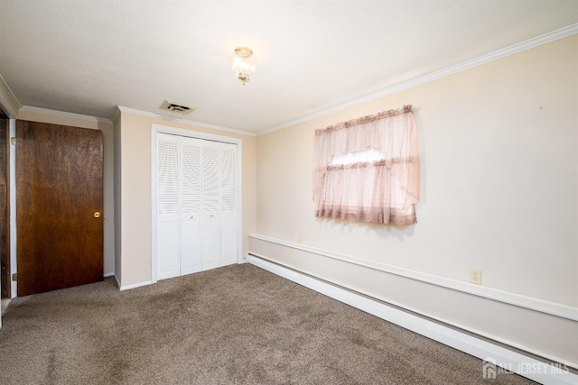 unfurnished bedroom featuring carpet, visible vents, a baseboard radiator, ornamental molding, and a closet