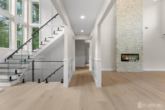116 Hunt Dr, Princeton, NJ 08540 - stairs with a high ceiling, wood finished floors, a fireplace, recessed lighting, and baseboards