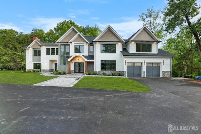 116 Hunt Dr, Princeton, NJ 08540 - view of front of house with french doors, asphalt driveway, stone siding, a chimney, and a garage
