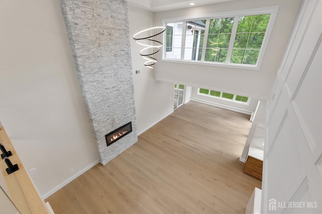 116 Hunt Dr, Princeton, NJ 08540 - unfurnished living room with wood finished floors and a stone fireplace