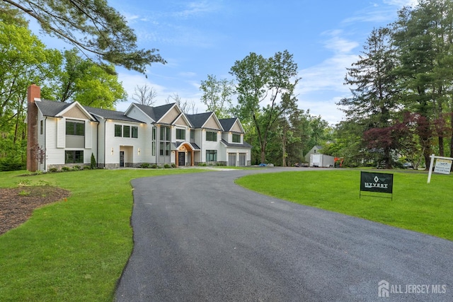 116 Hunt Dr, Princeton, NJ 08540 - view of property featuring a front lawn, a chimney, and driveway