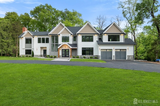 116 Hunt Dr, Princeton, NJ 08540 - view of front facade with stone siding, french doors, a garage, a front lawn, and a chimney