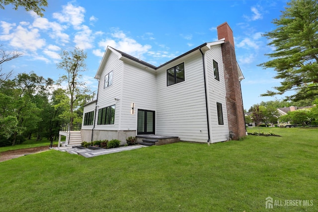 116 Hunt Dr, Princeton, NJ 08540 - back of property featuring a chimney, a lawn, and french doors