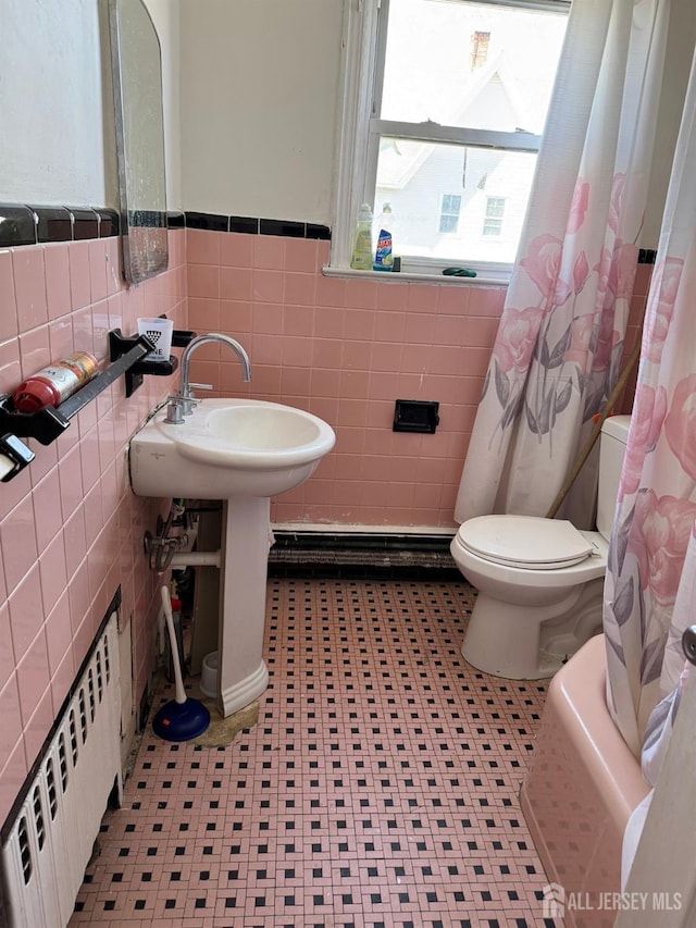 87-89 1st St, Perth Amboy, NJ 08861 - full bathroom with a wainscoted wall, toilet, a shower with curtain, radiator heating unit, and tile walls