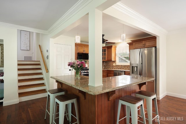 505 Runyon Ave, Piscataway, NJ 08854 - kitchen with appliances with stainless steel finishes, brown cabinets, dark wood-style flooring, tasteful backsplash, and a kitchen bar