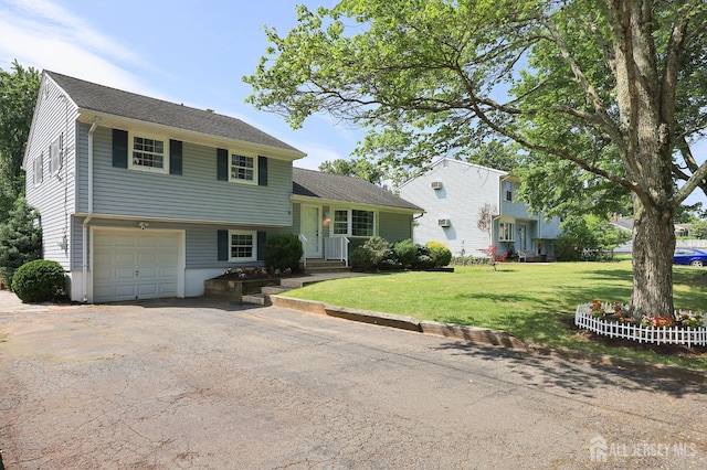 505 Runyon Ave, Piscataway, NJ 08854 - split level home with asphalt driveway, a front yard, and an attached garage