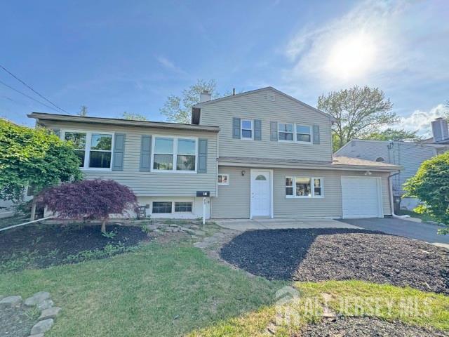 43 Overbrook Dr, Colonia, NJ 07067 - split level home featuring an attached garage, asphalt driveway, and a front lawn