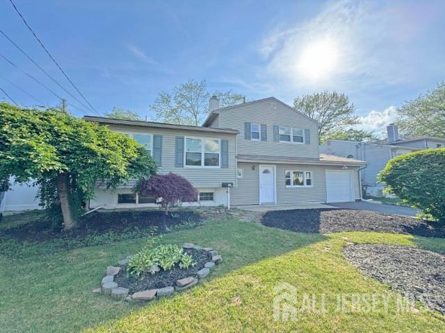 43 Overbrook Dr, Colonia, NJ 07067 - tri-level home featuring a garage, a front yard, and asphalt driveway