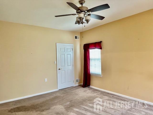 empty room with baseboards, carpet, and ceiling fan
