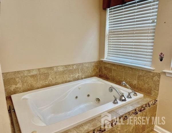 full bathroom with a whirlpool tub