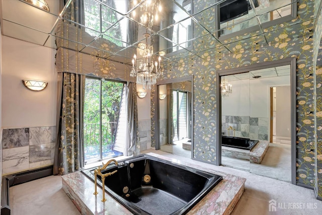 403 New Dover Rd, Colonia, NJ 07067 - bathroom with wallpapered walls, a chandelier, a tub with jets, a wainscoted wall, and baseboard heating