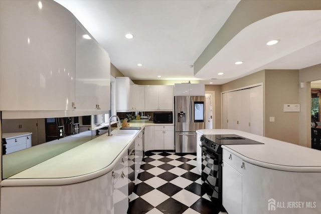 403 New Dover Rd, Colonia, NJ 07067 - kitchen with black appliances, light countertops, white cabinets, a center island, and recessed lighting