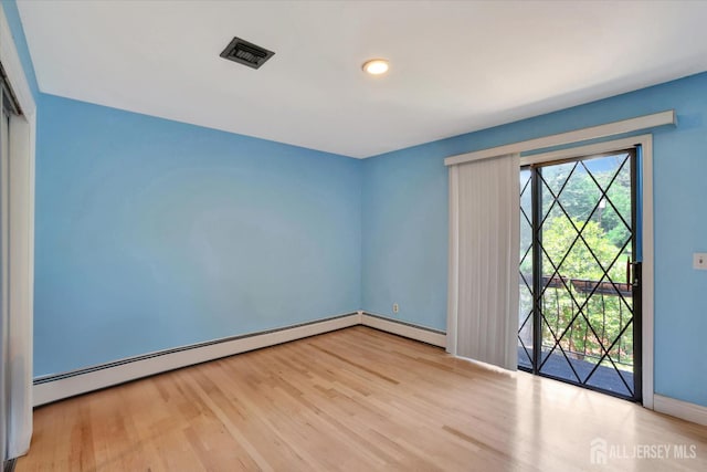 403 New Dover Rd, Colonia, NJ 07067 - unfurnished room featuring a baseboard heating unit and wood finished floors
